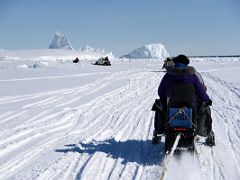 01C Ski-Doos Lead Qamutiik Sleds At The Beginning Of Day 1 With Icebergs Beyond On Floe Edge Adventure Nunavut Canada